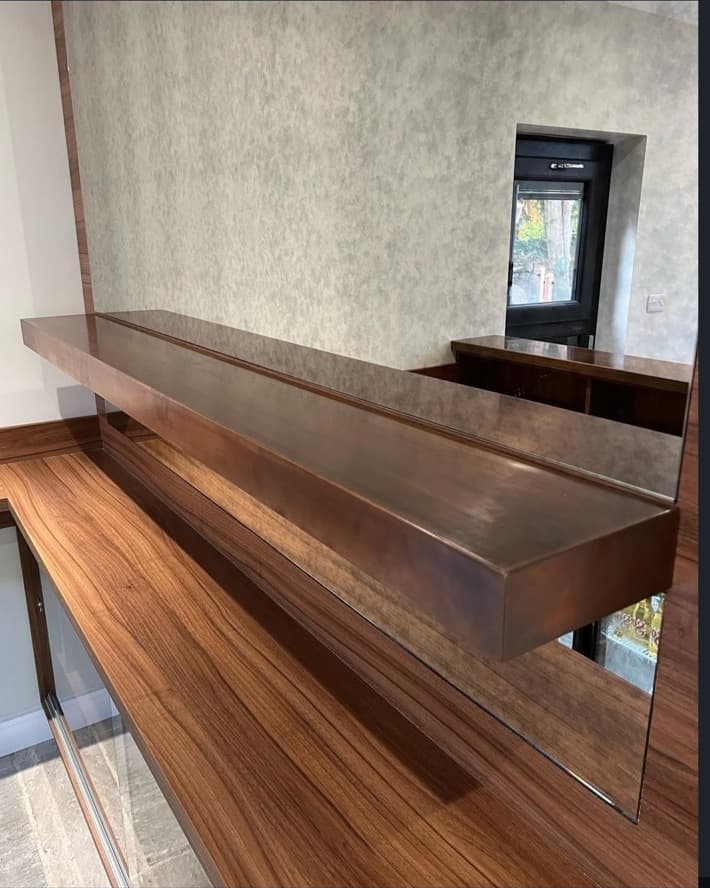 Close-up of the bespoke timber bar shelf and antique mirror detailing.