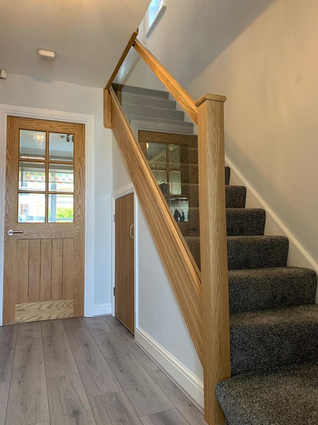 Oak and glass staircase with clear balustrade.