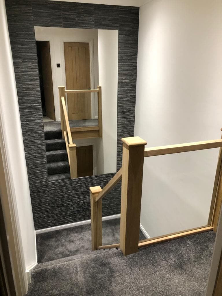 Oak and glass staircase in a renovated hall and landing.