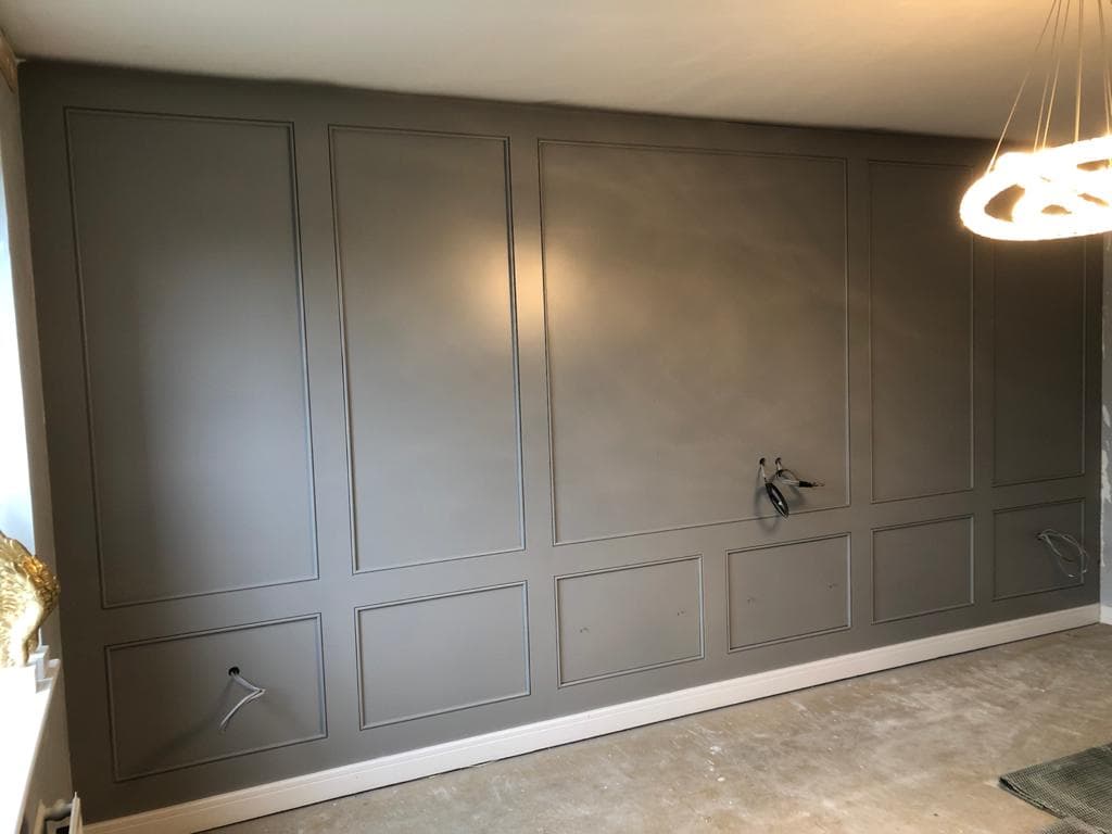 Grey panelled television wall.