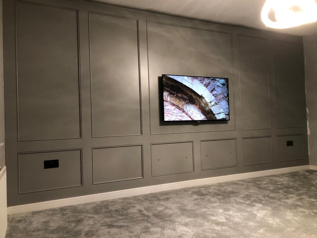 Grey panelled television wall.