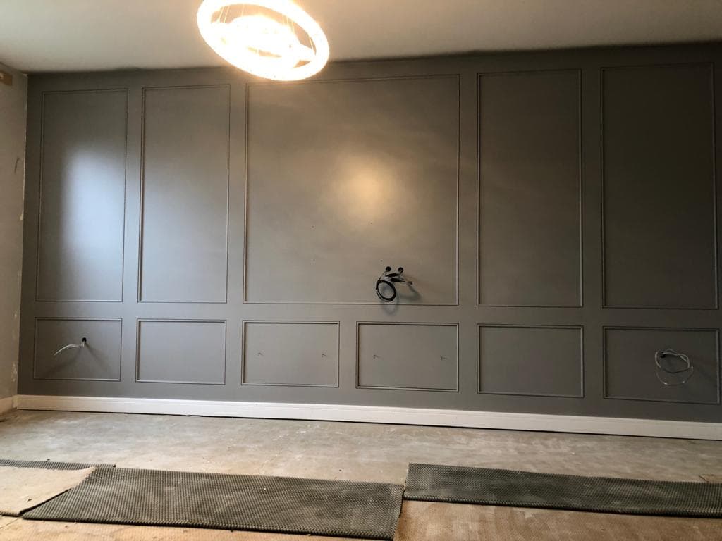 Grey panelled television wall.