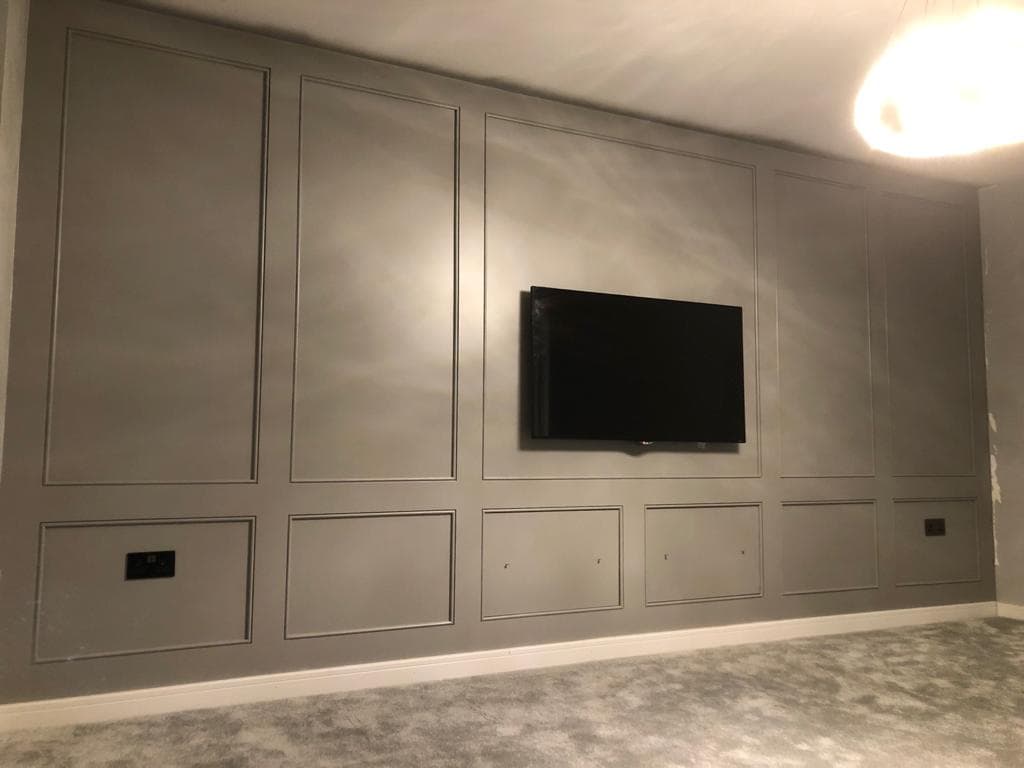 Grey panelled television wall.