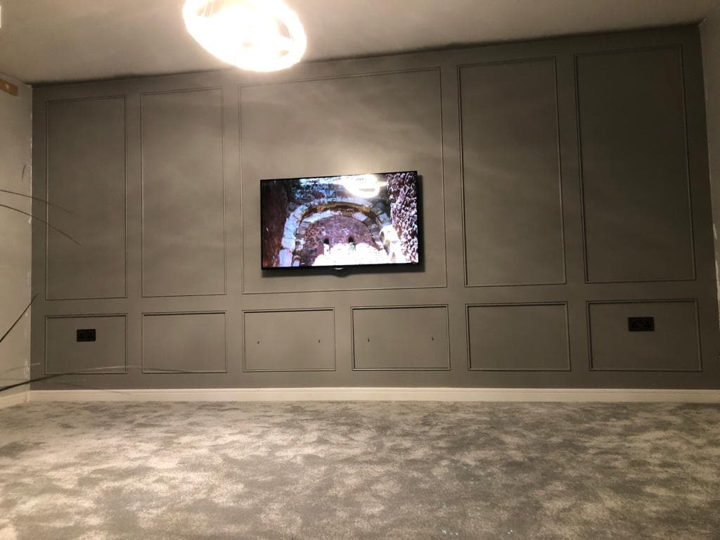 Grey panelled television wall.