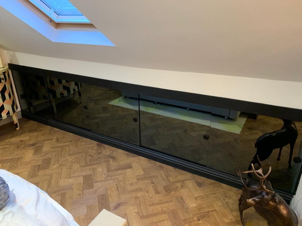 Bespoke wardrobe installation in a loft room.