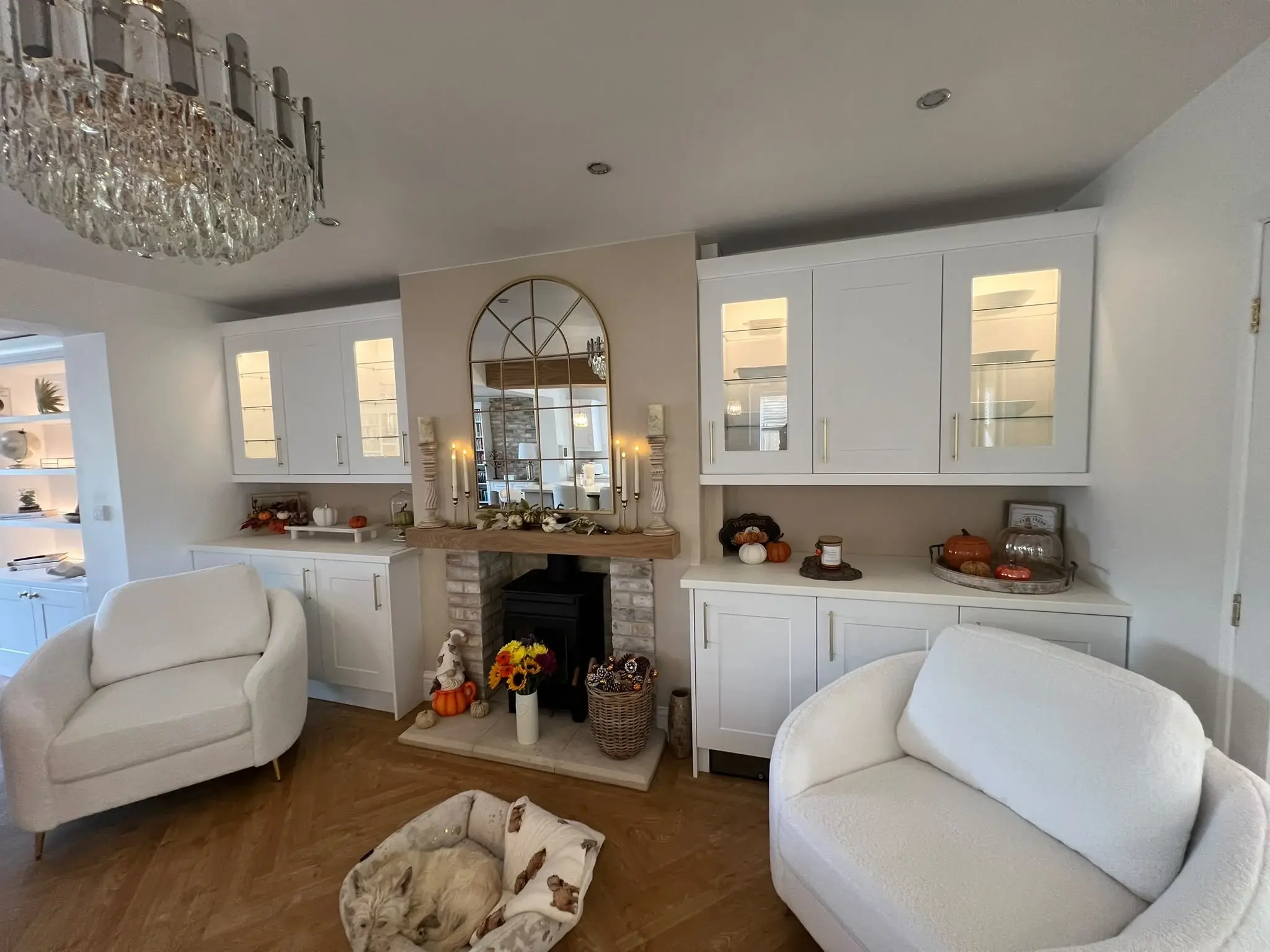 Front view of the separate fireplace and its matching white glazed cabinetry.