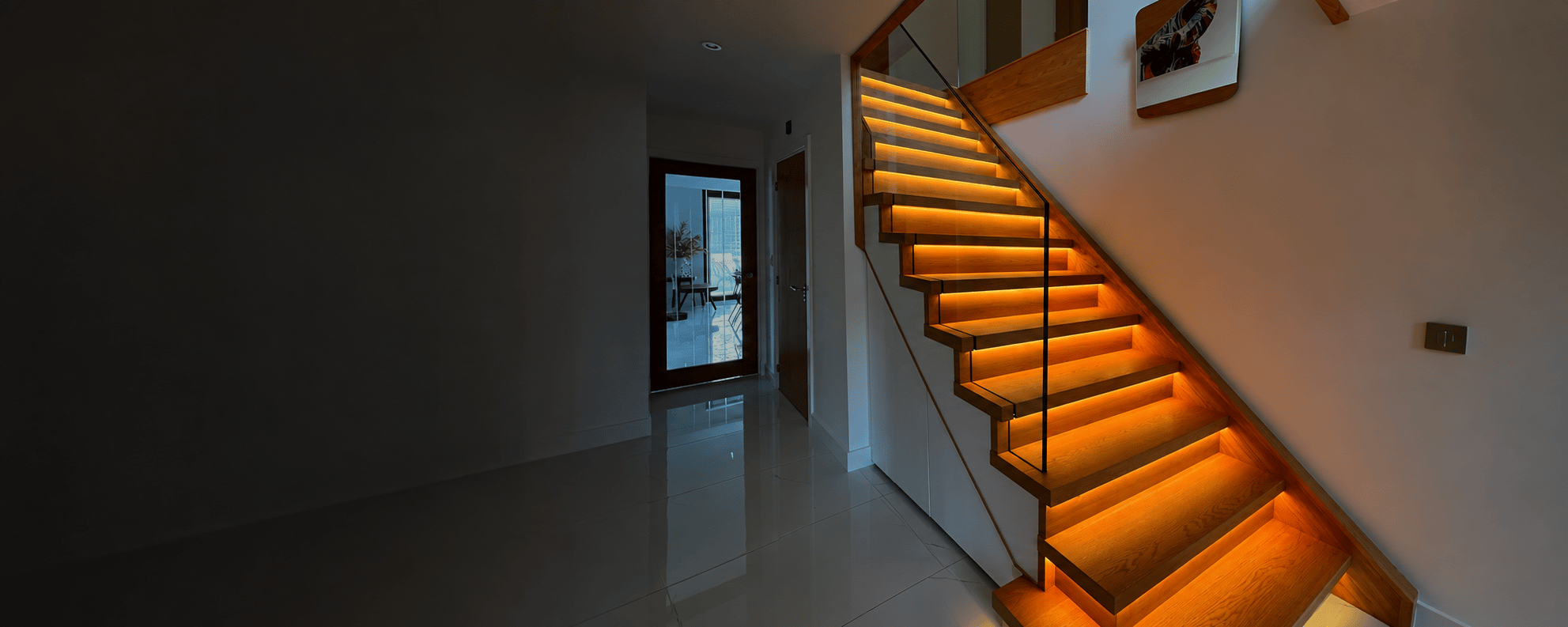 Oak staircase with glass balustrade and integrated lighting