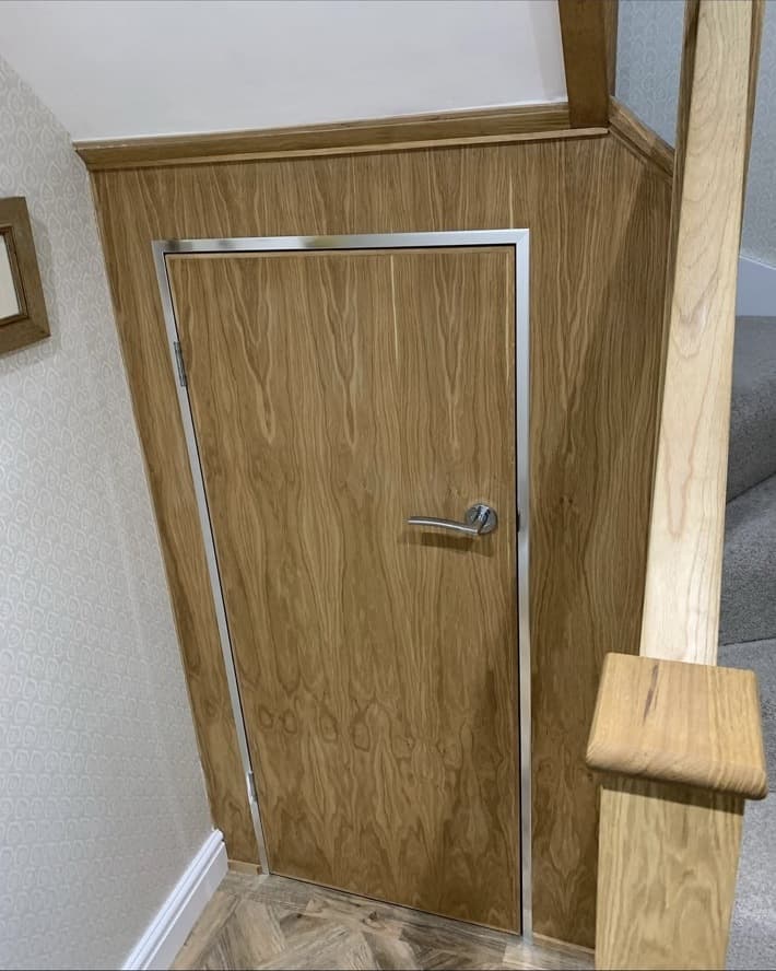 Integrated oak door and panelling fitted beneath the renovated staircase.