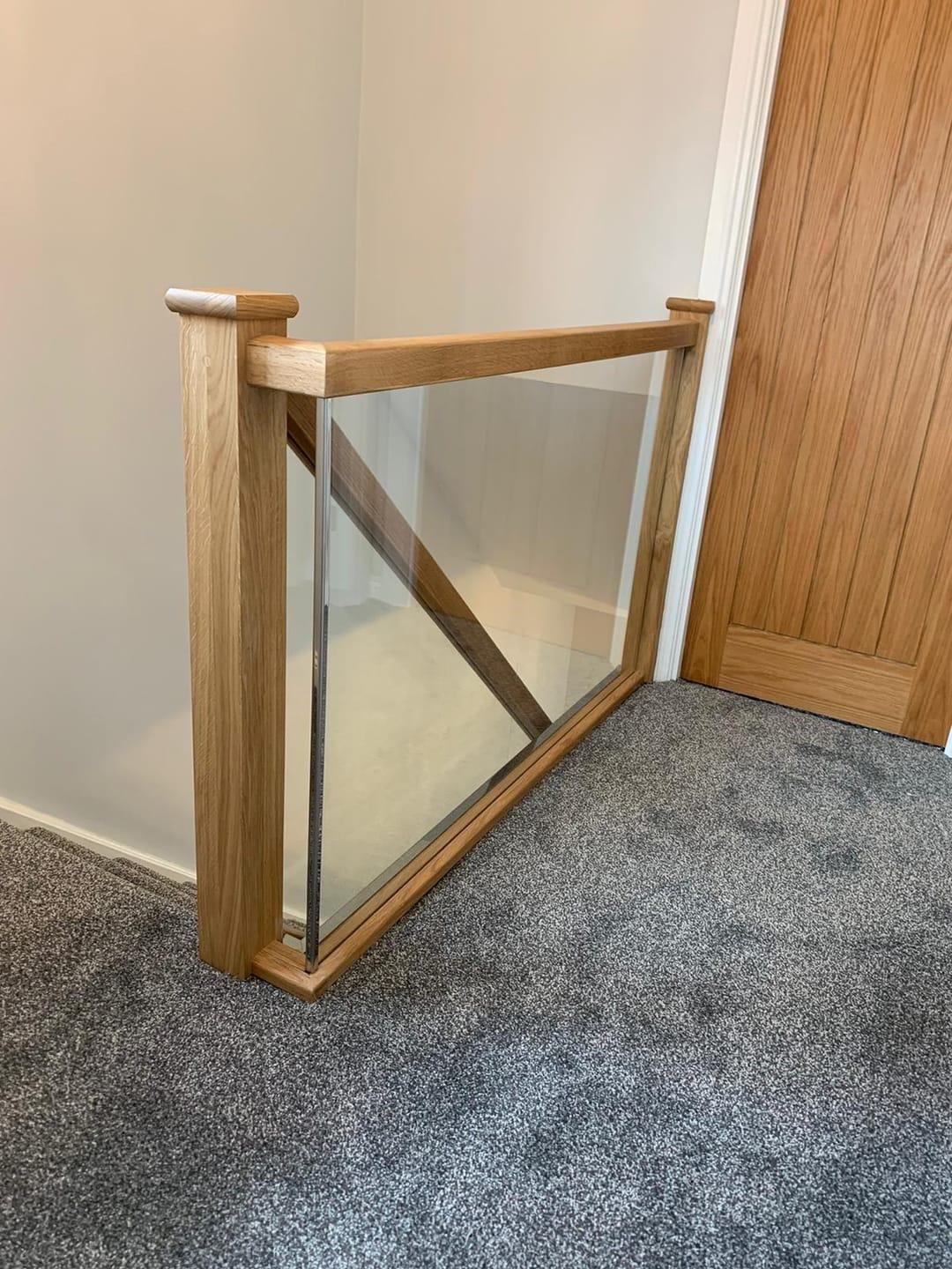 Oak and glass staircase with clear balustrade.