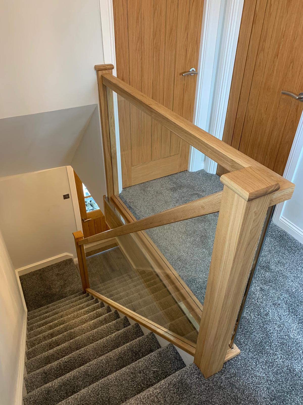 Oak and glass staircase with clear balustrade.