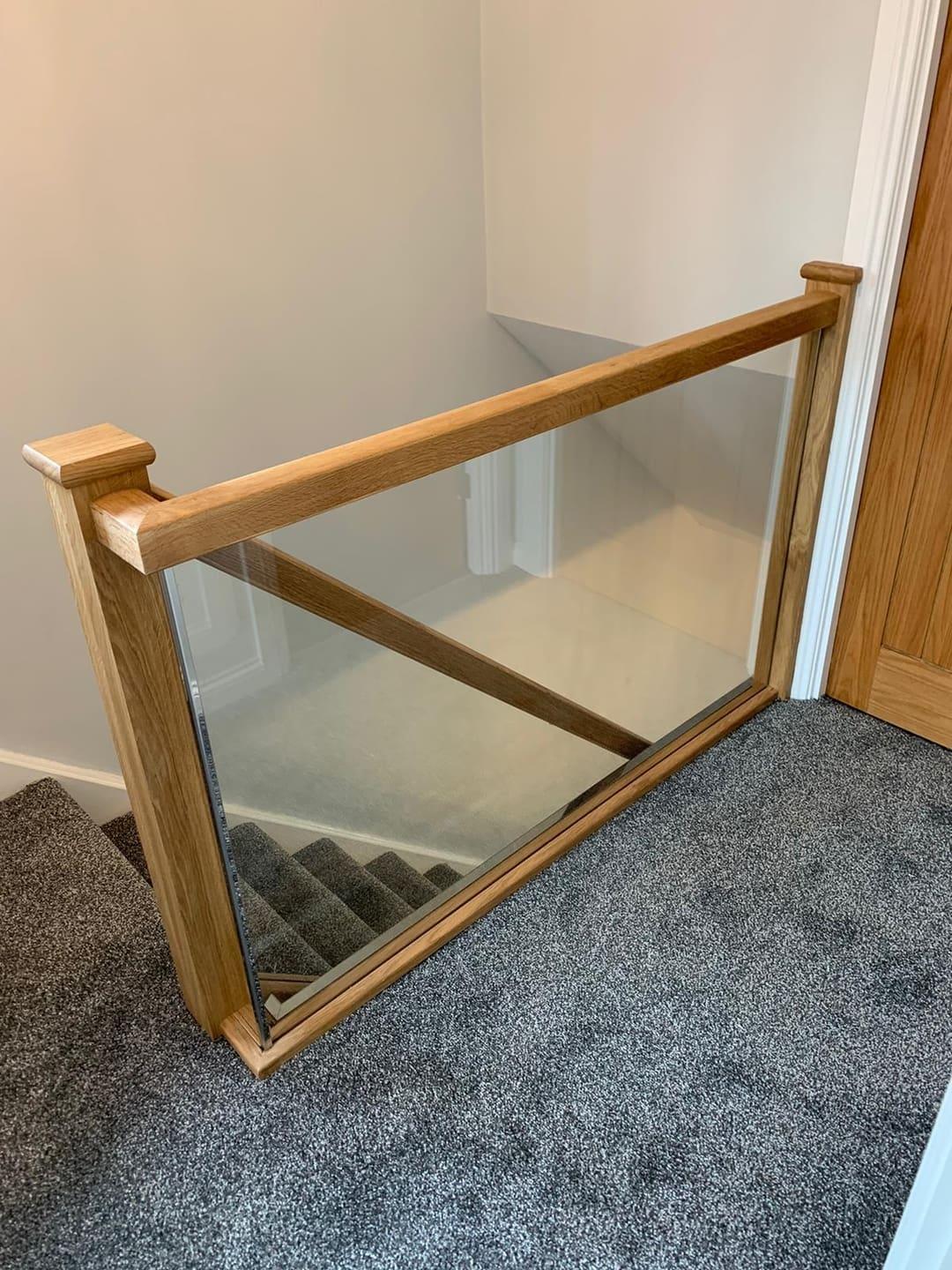 Oak and glass staircase with clear balustrade.