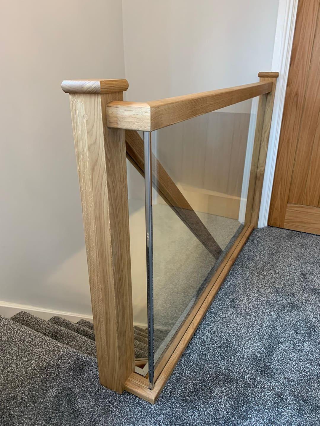 Oak and glass staircase with clear balustrade.