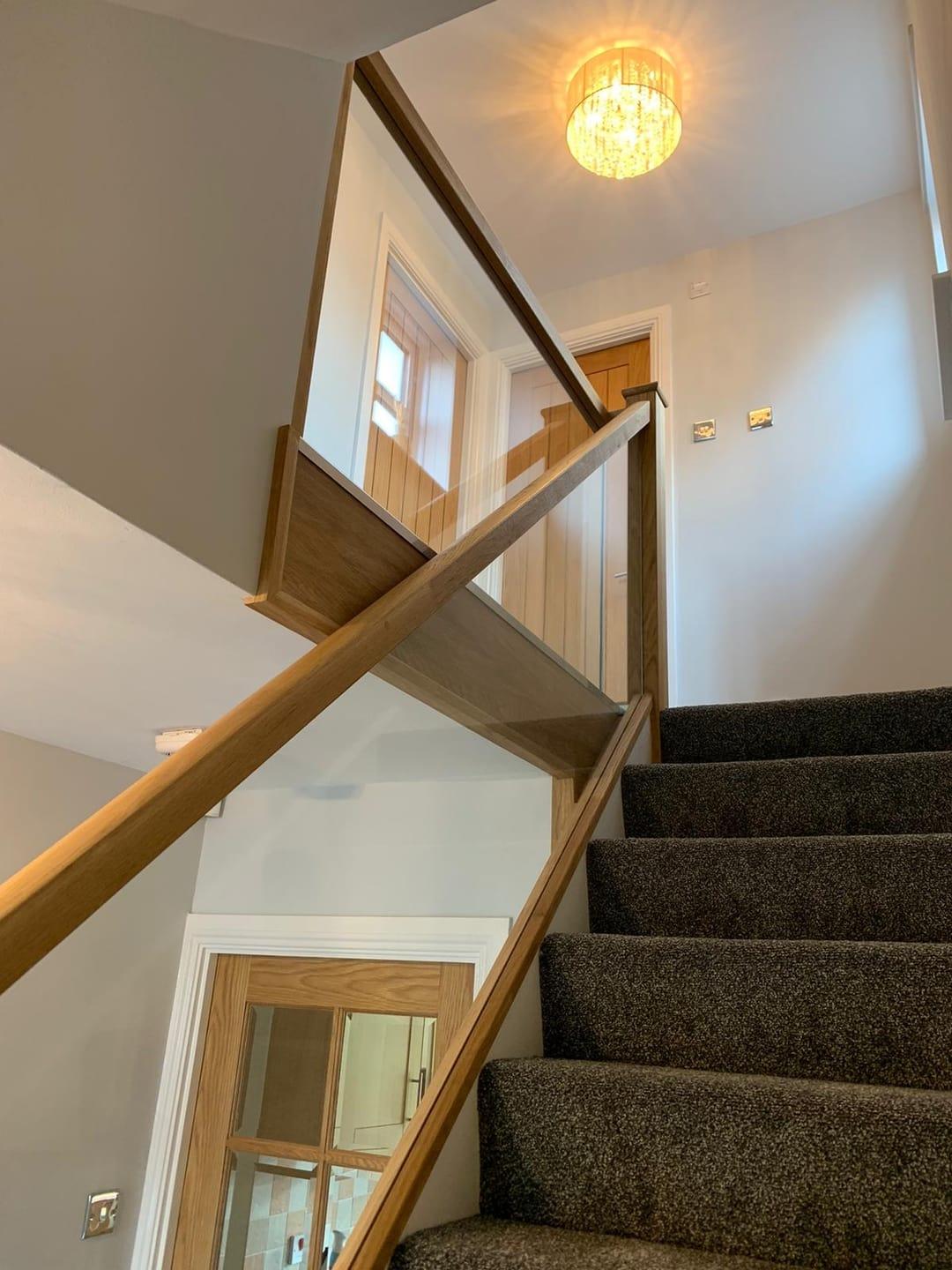 Oak and glass staircase with clear balustrade.