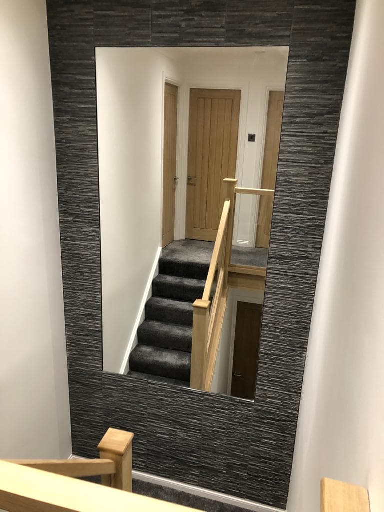 Oak and glass staircase in a renovated hall and landing.
