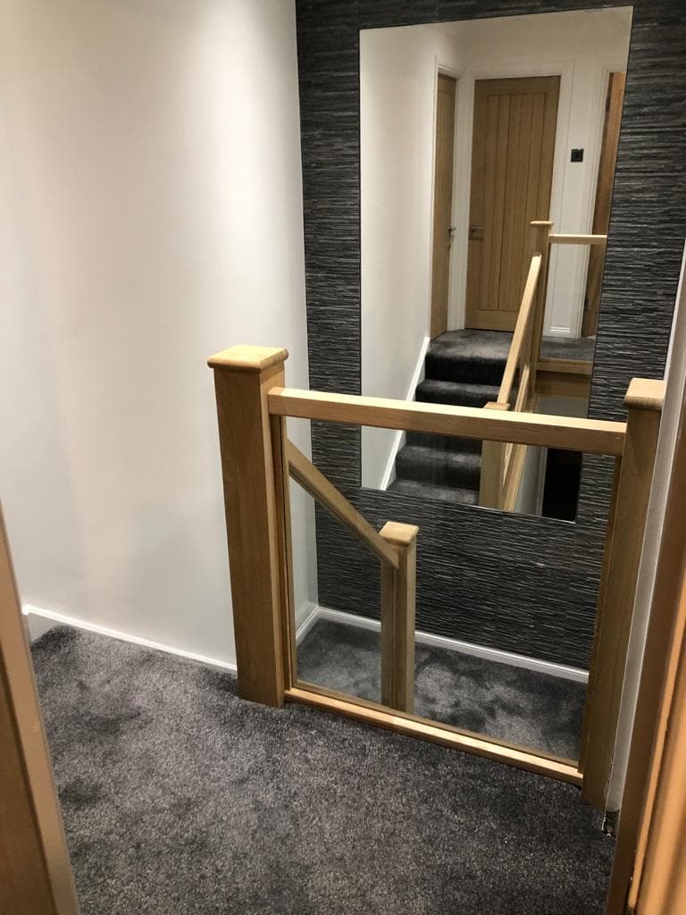 Oak and glass staircase in a renovated hall and landing.