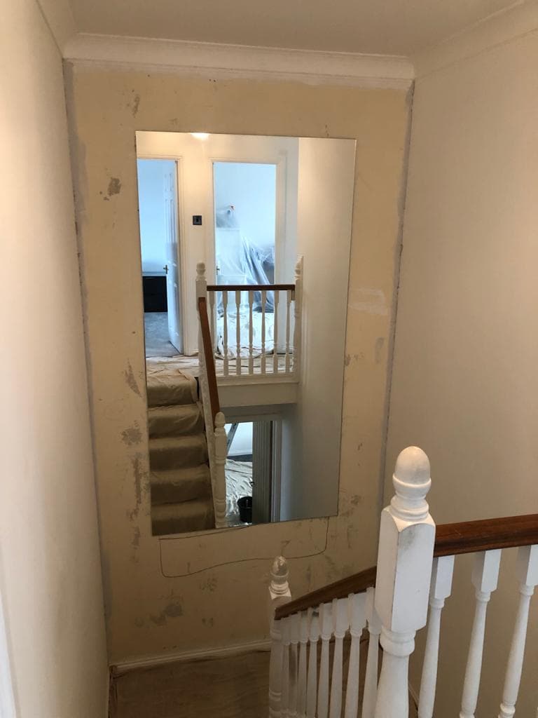 Oak and glass staircase in a renovated hall and landing.